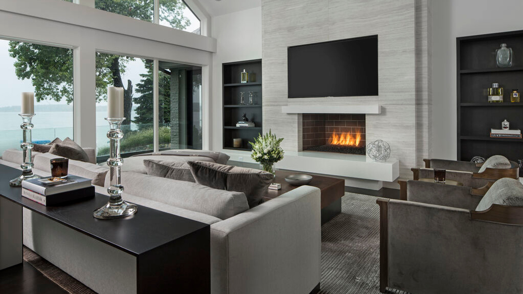 Contemporary lake house living room overlooking the water